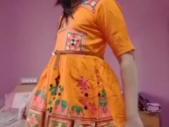 'Indian crossdresser in a traditional red embroidery dress.'